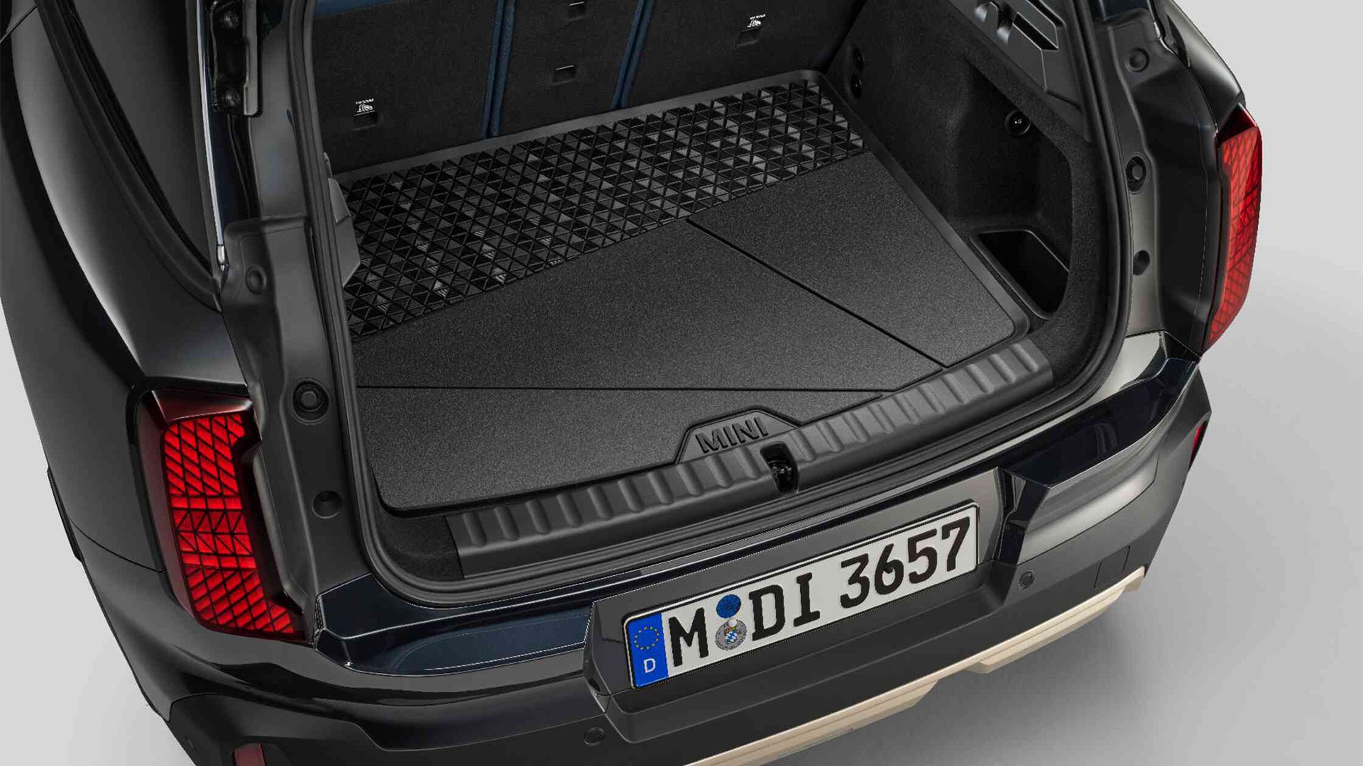 Black, custom-fit MINI boot compartment mat with high all-round edge to protect against dirt and moisture.